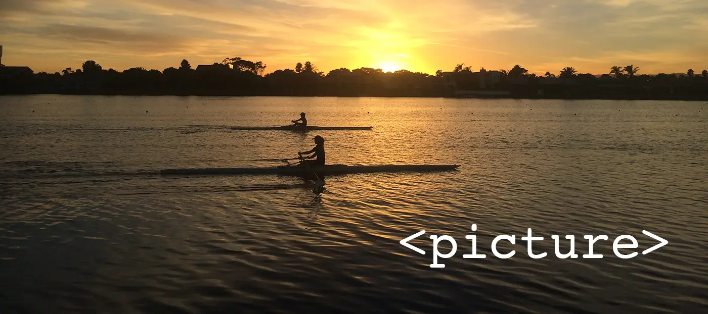 A person rowing during sunset